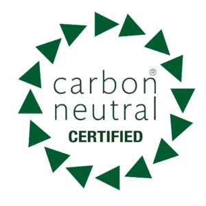 Green Initiative "Carbon Neutral Certified" logo featuring a dark green text label enclosed within a circular border of 15 dark green triangles pointing clockwise.